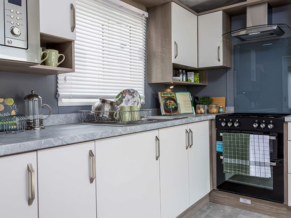A kitchen with oven and sink at Sandy Shores - Hayling Island