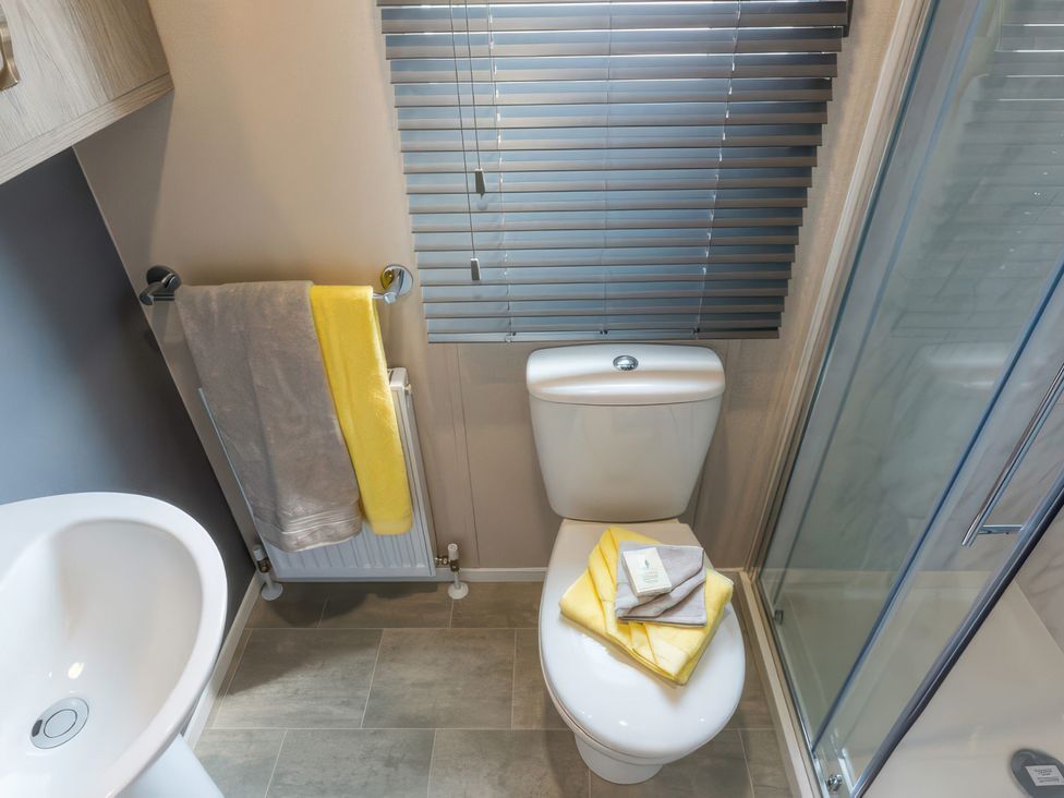 A bathroom with a toilet, sink, and shower at Sandy Shores - Hayling Island