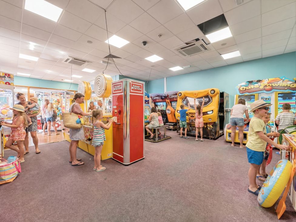 An arcade with various machines and children playing at Harbour Haven - Hayling Island