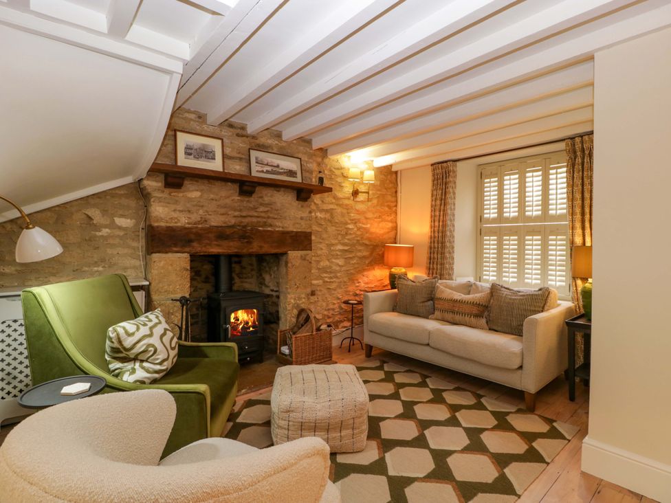 A living room with furniture and a fireplace at The Cottage in Stow-On-The-Wold