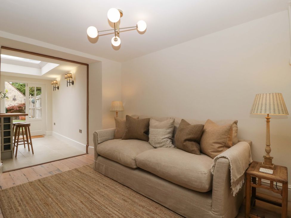 A living room with a sofa and lamp at The Cottage in Stow-On-The-Wold