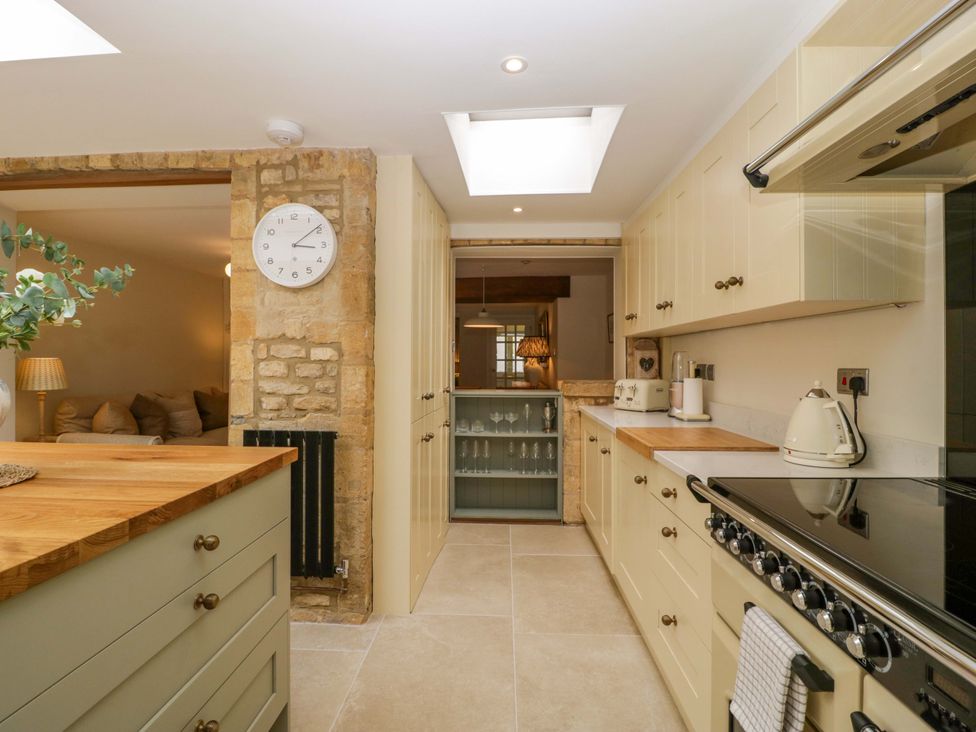 A kitchen with countertops and appliances at The Cottage in Stow-On-The-Wold