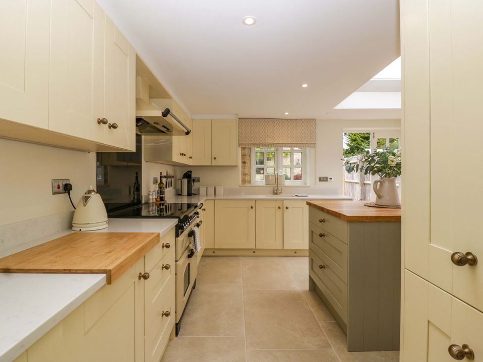 A kitchen with cabinets, appliances and countertop at The Cottage in Stow-On-The-Wold