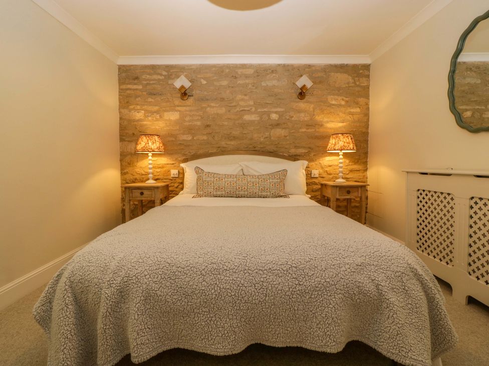 A bedroom with a bed and bedside tables at The Cottage in Stow-On-The-Wold