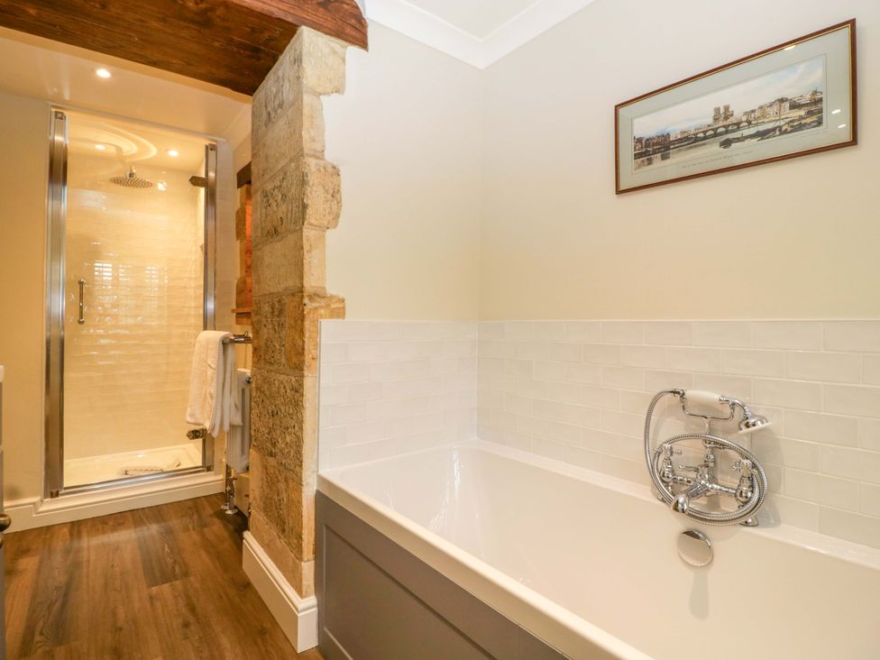 A bathroom featuring a bathtub and shower at The Cottage in Stow-On-The-Wold
