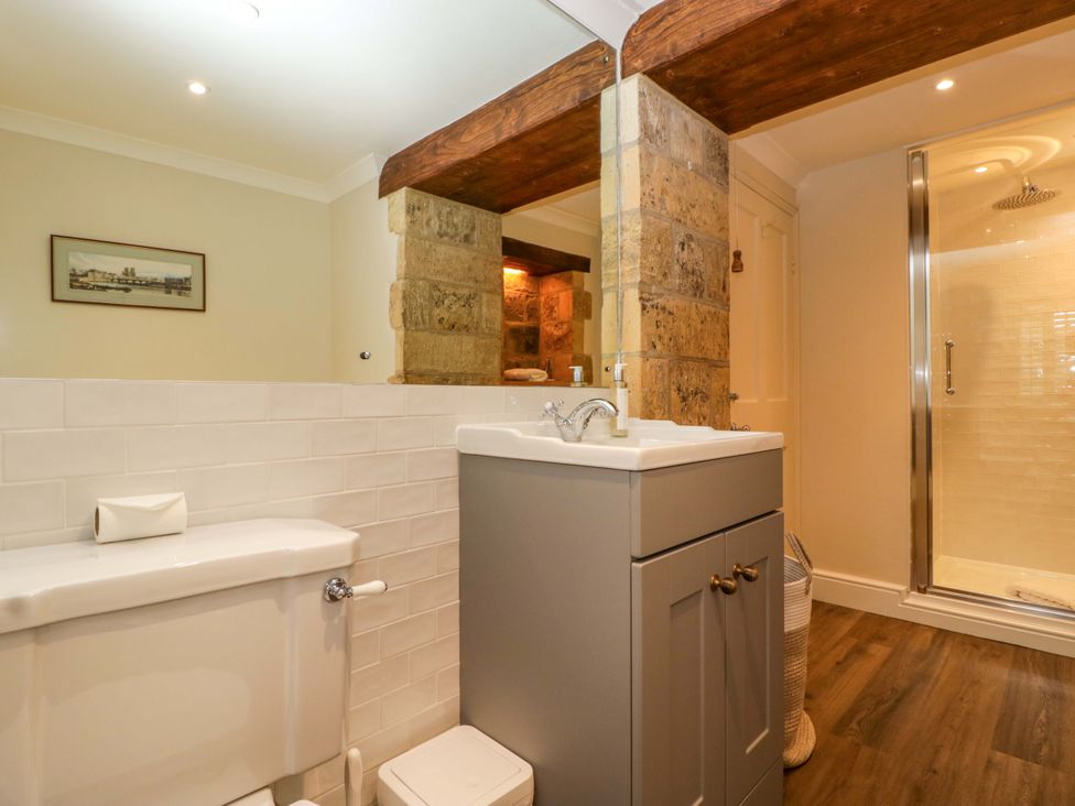 A bathroom with a sink, toilet, and shower at The Cottage in Stow-On-The-Wold