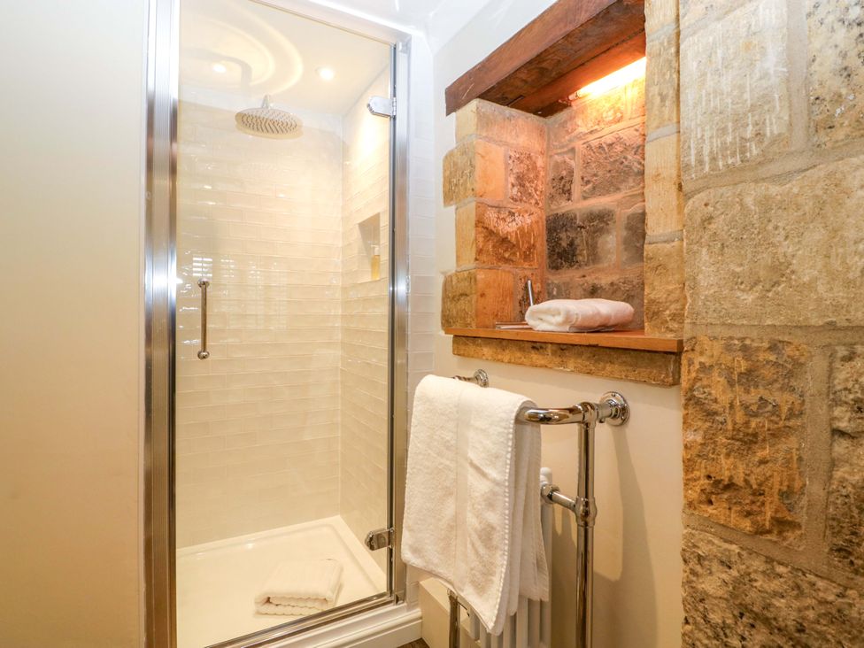 A bathroom with a shower and towel rail at The Cottage in Stow-On-The-Wold