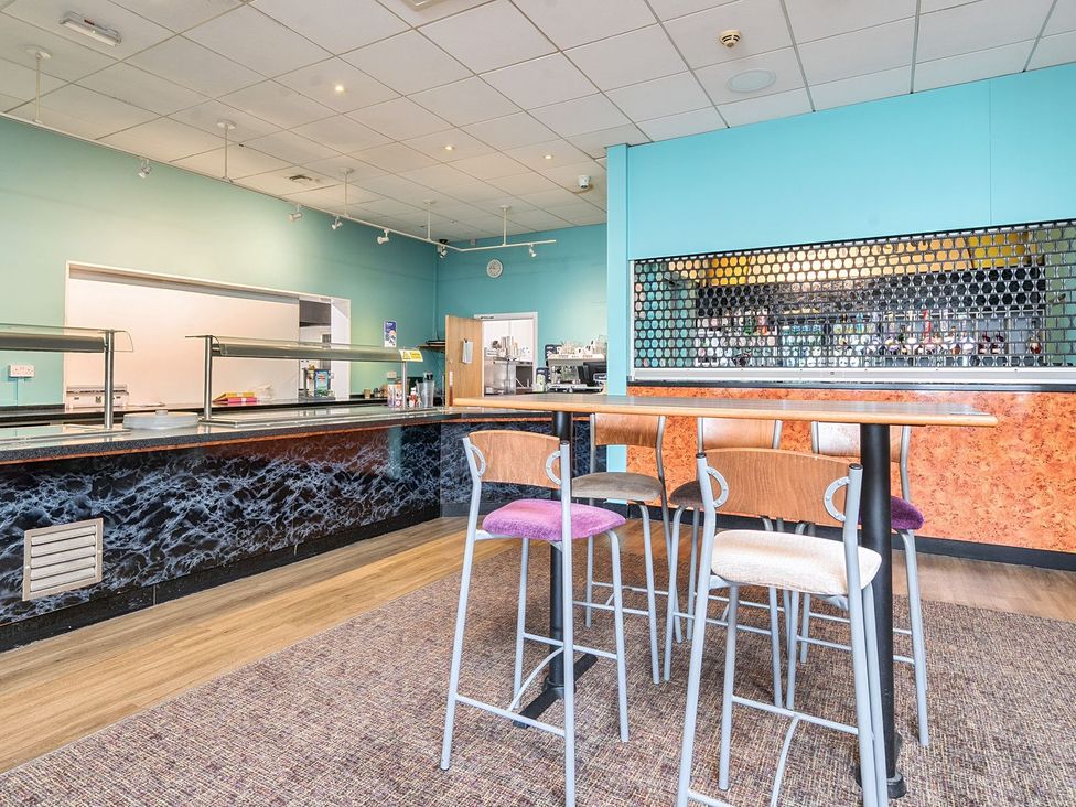 A dining area with bar stools and counter at The Lookout - Hayling Island