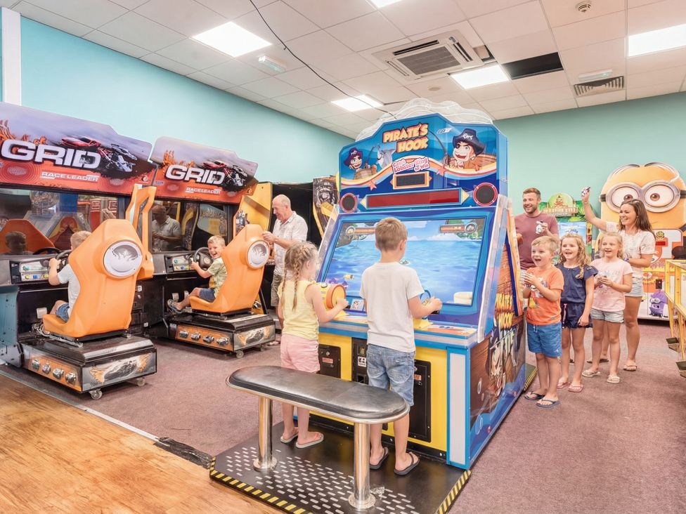 An arcade with children playing games at Sunset Sands - Hayling Island