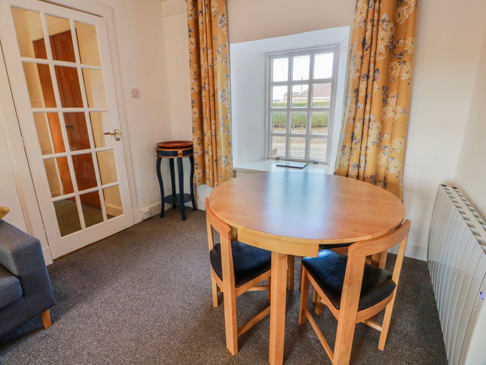 A dining room with a table and chairs at The Old Coach House in Lockerbie