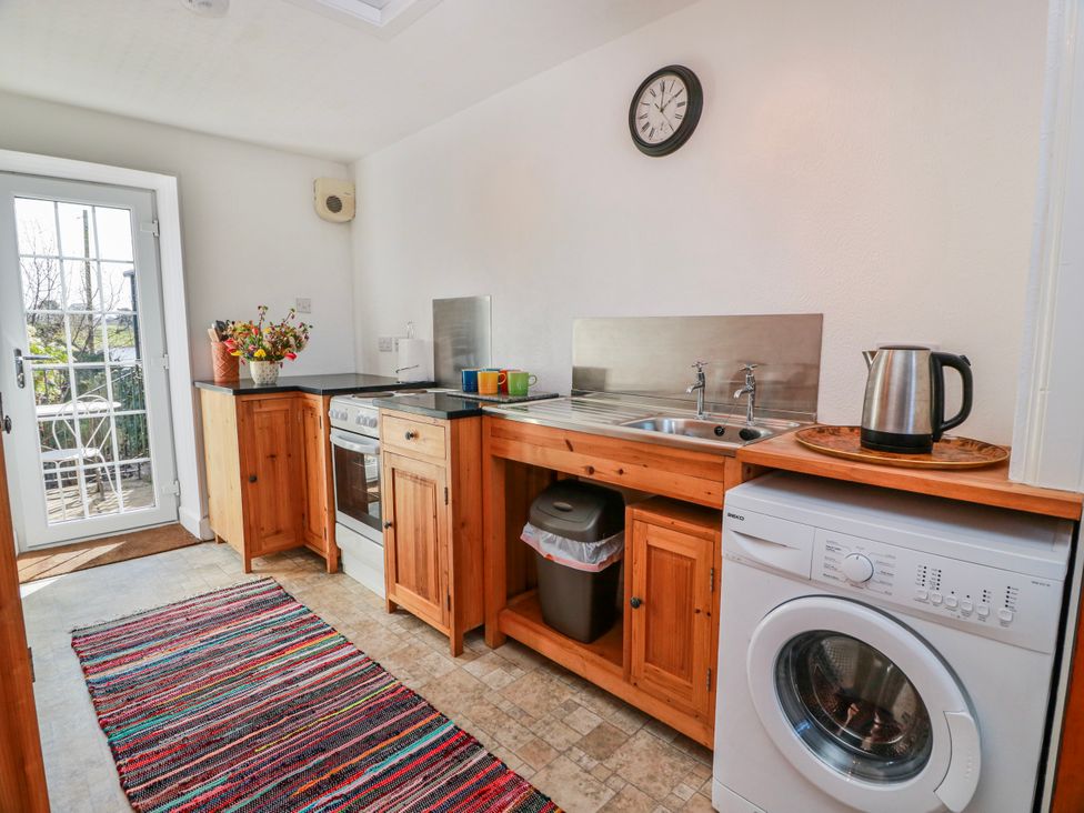 A kitchen with a sink and oven at The Old Coach House in Lockerbie