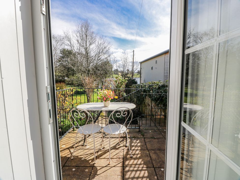 A patio with a table and chairs at The Old Coach House Lockerbie