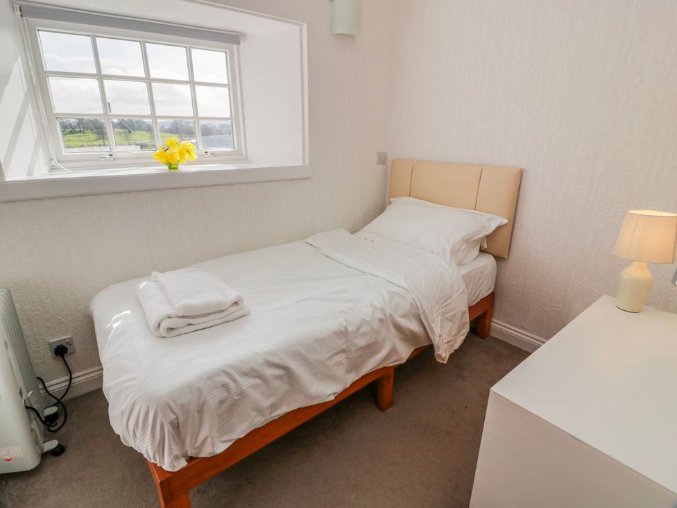 A bedroom with a bed and dressing table at The Old Coach House Lockerbie