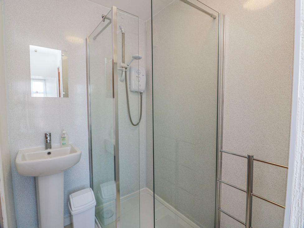 A bathroom with a shower and sink at The Old Coach House Lockerbie