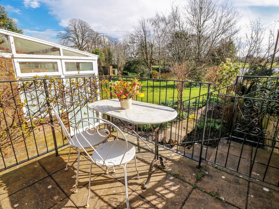 A garden area with a table and chairs at The Old Coach House Lockerbie