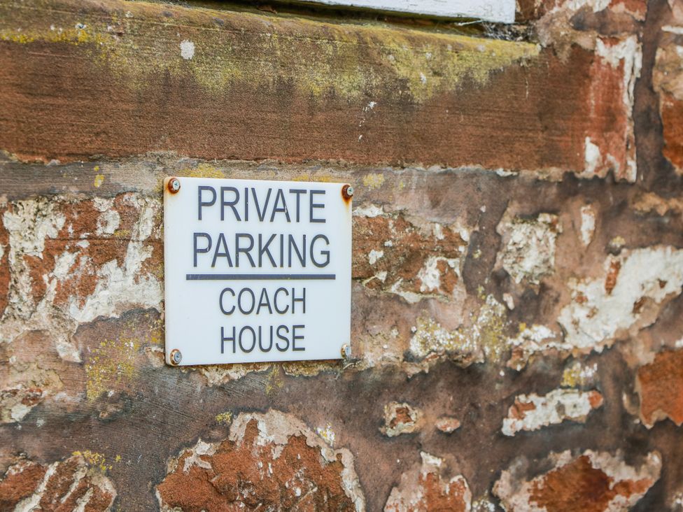 A private parking sign on a stone wall at The Old Coach House Lockerbie