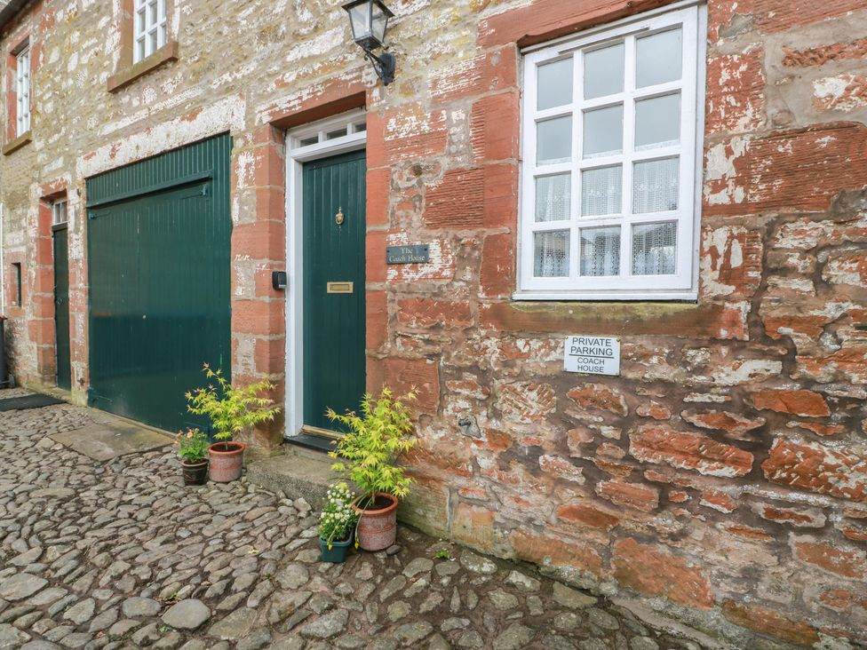 An exterior view of The Coach House with plants at The Old Coach House in Lochmaben