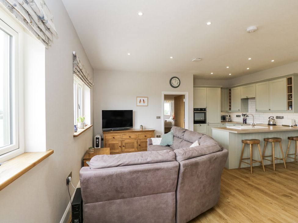 A living room with a sofa and television at Hayloft