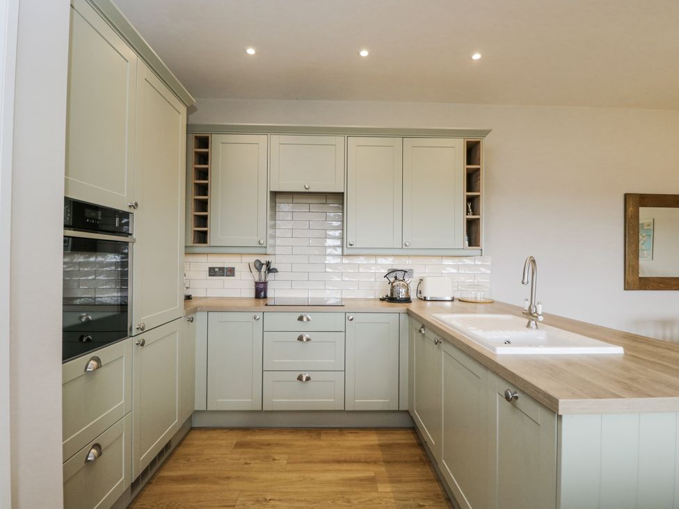 A kitchen with cabinets and appliances at Hayloft