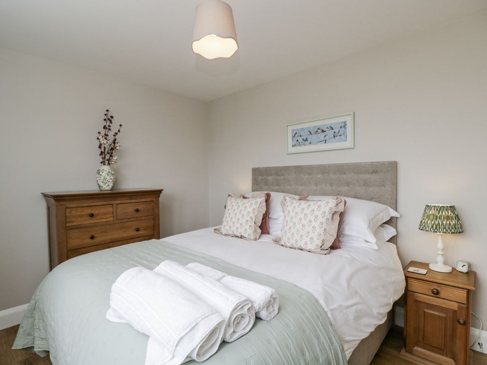 A bedroom with a bed and dresser at Hayloft