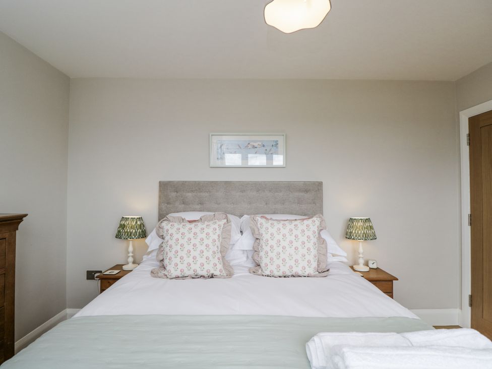 A bedroom with a bed and lamps at Hayloft