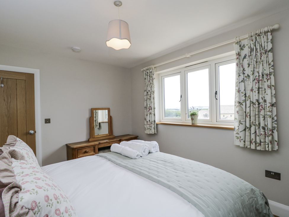 A bedroom with a bed and a dressing table at Hayloft