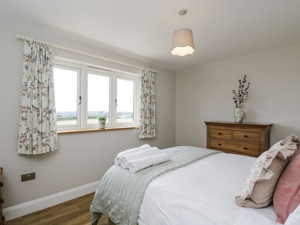 A bedroom with a bed and window at Hayloft 