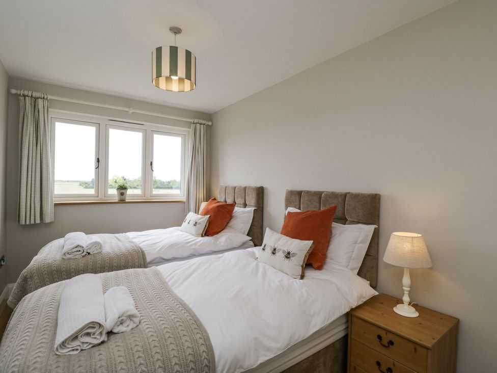 A bedroom with two beds and a lamp at Hayloft in 