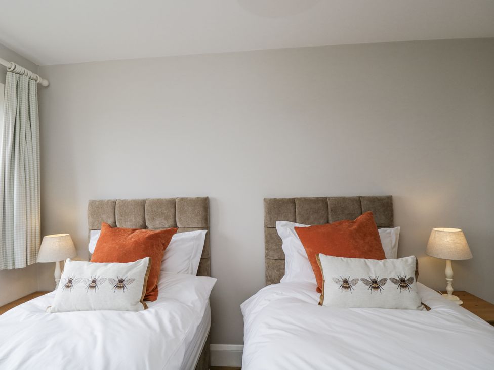 Two single beds with pillows and a lamp in a bedroom at Hayloft