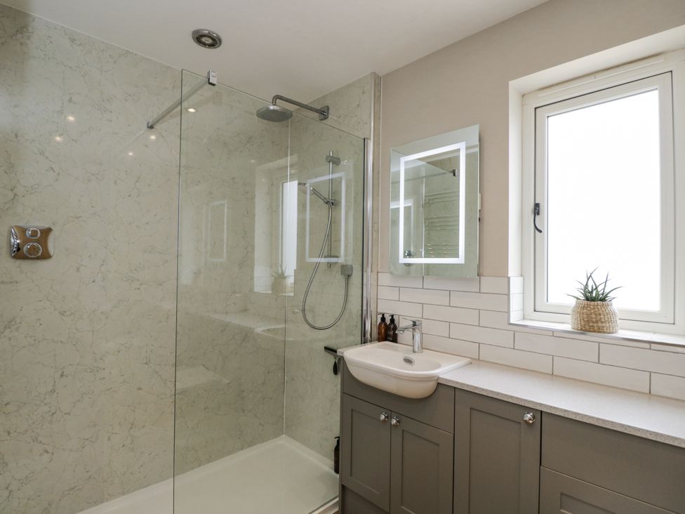 A bathroom with a shower and sink at Hayloft