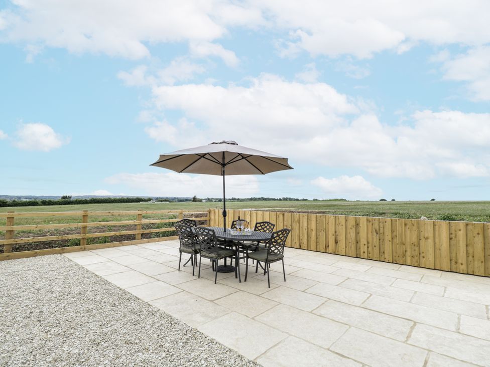 An outdoor seating area with a table and chairs at Hayloft