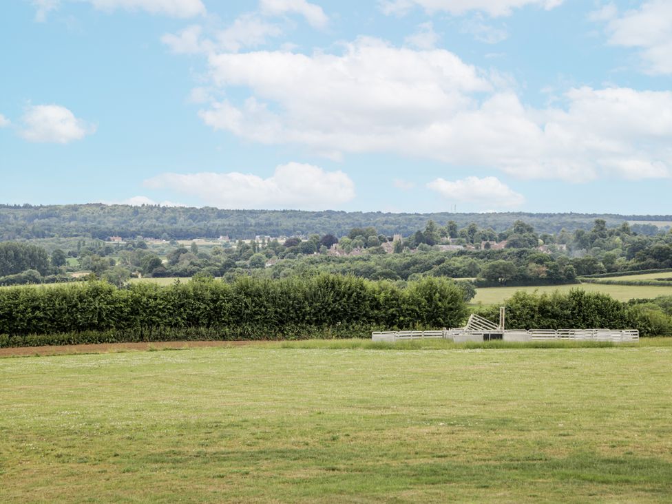 A field with trees and a fence at Hayloft in 