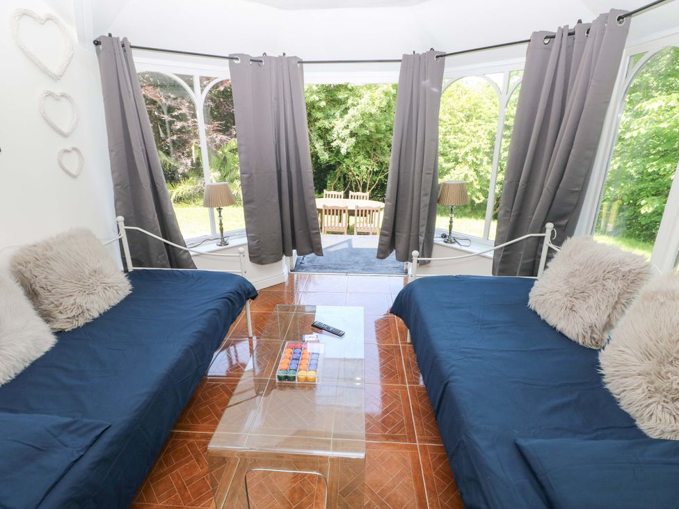 A snug with sofas and a view of outdoor seating at 170 Langland Road Mumbles