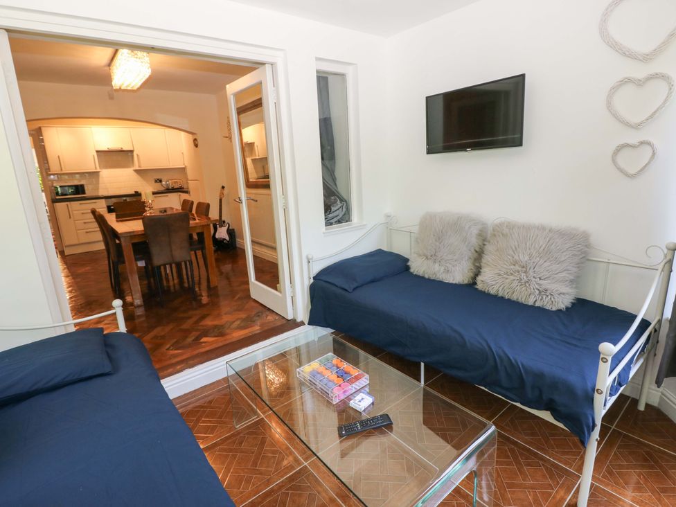 A living room with a sofa and coffee table at 170 Langland Road in Mumbles