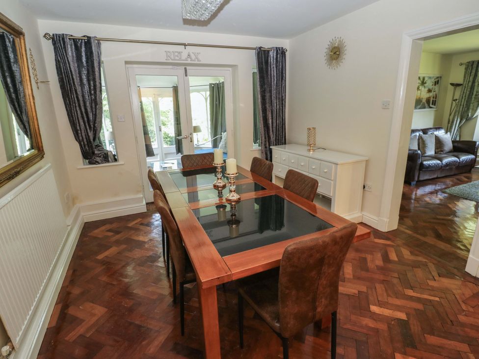 A dining room with a table and chairs at 170 Langland Road in Mumbles