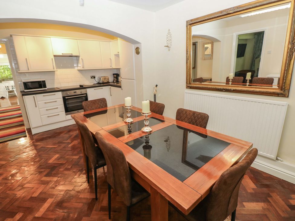 A dining room with a table and chairs at 170 Langland Road Mumbles