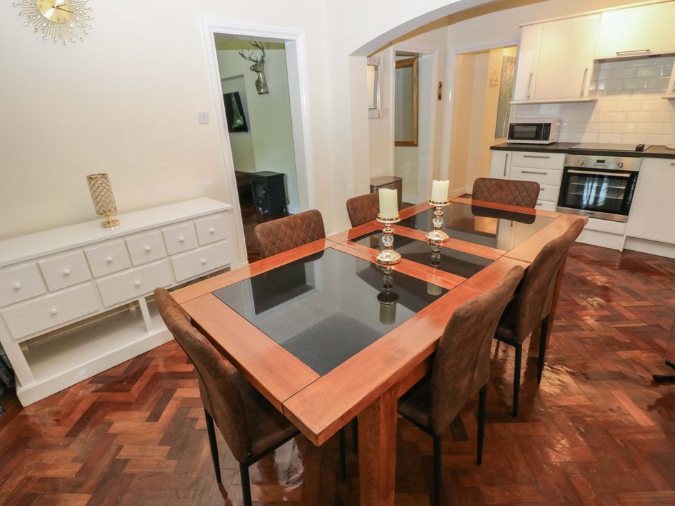 A dining room with a table and chairs at 170 Langland Road in Mumbles