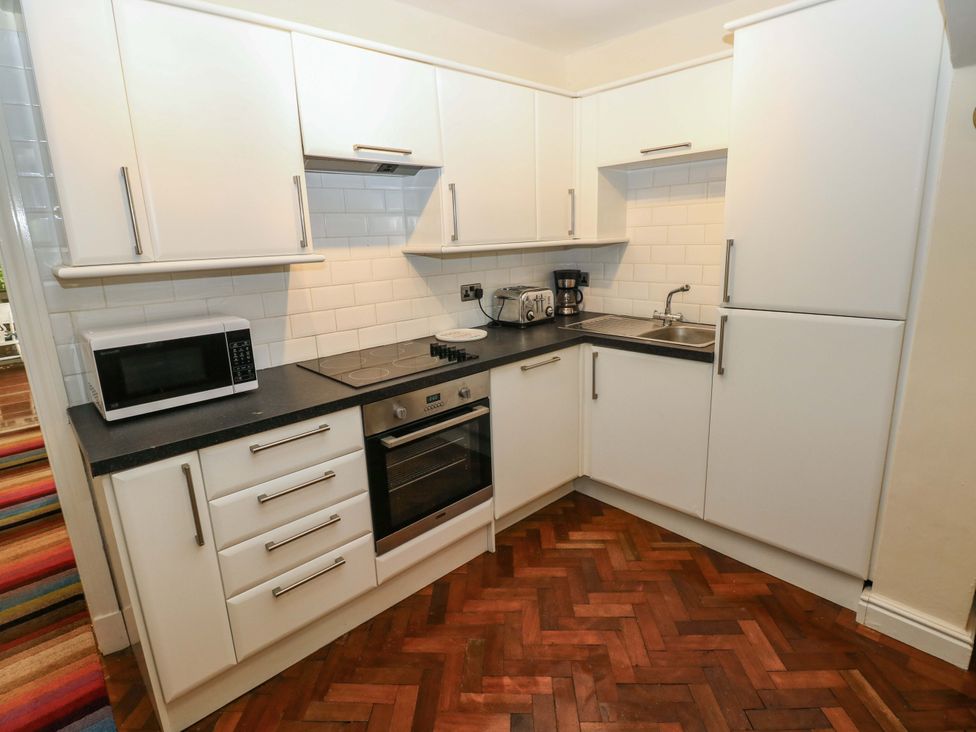 A kitchen with appliances and cabinetry at 170 Langland Road Mumbles