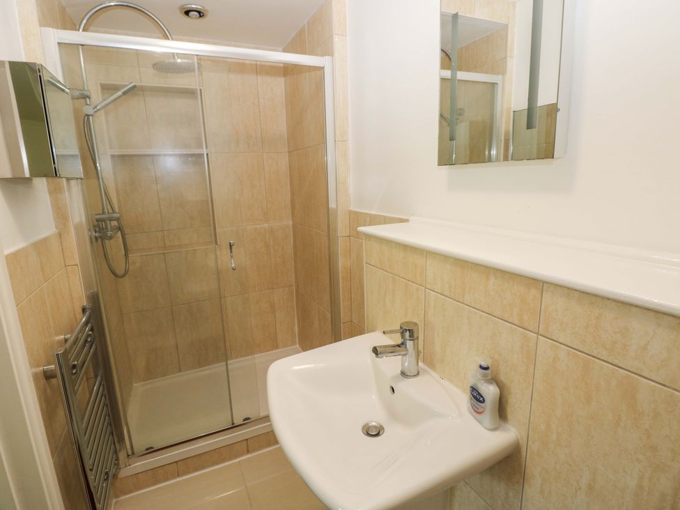 A bathroom with a shower and sink at 170 Langland Road, Mumbles