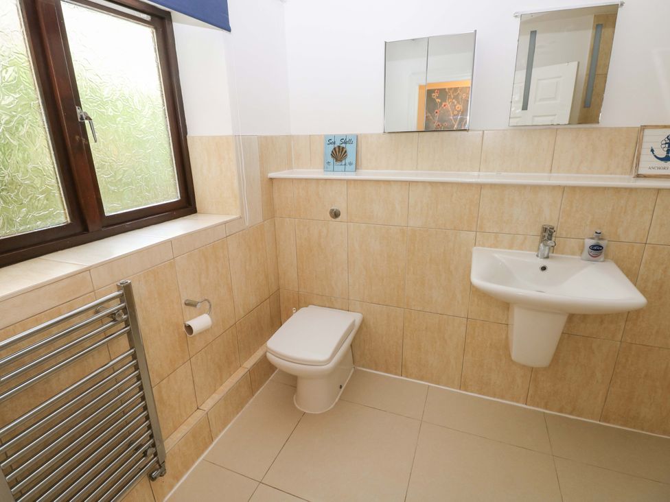 A bathroom with a toilet and sink at 170 Langland Road Mumbles