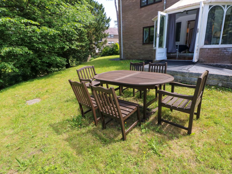A table with chairs in a garden at 170 Langland Road Mumbles