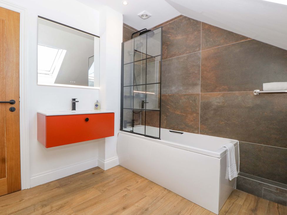 A bathroom with a bathtub and sink at Forest Lodge in Pontyclun