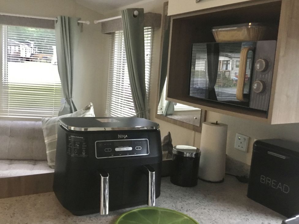 A kitchen with a Ninja appliance and microwave at 38 The Green