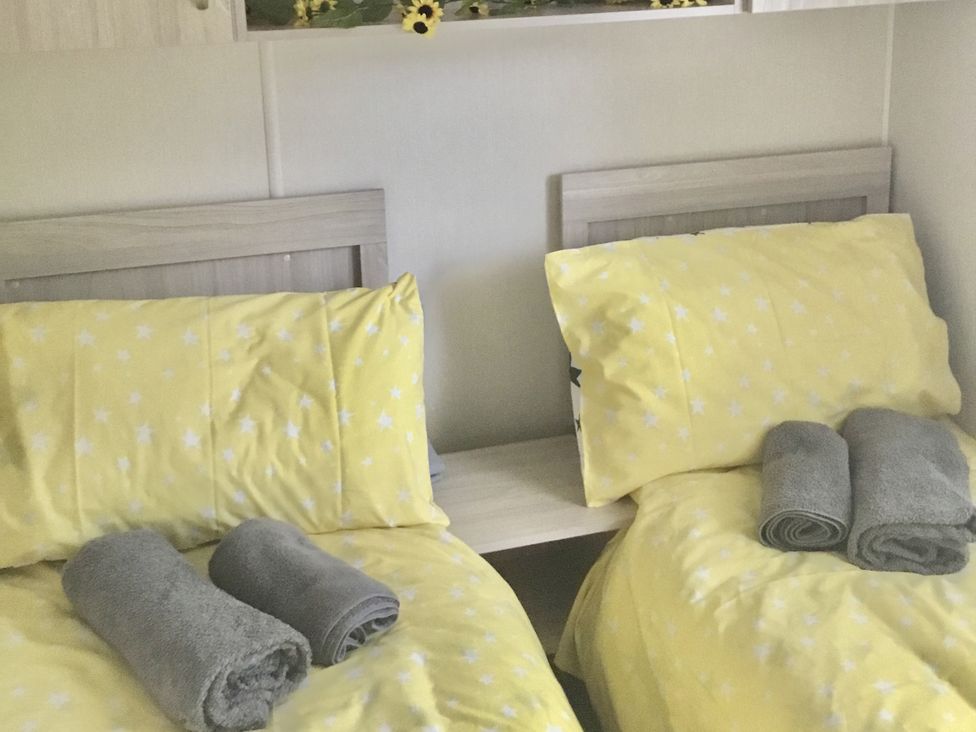 A bedroom with twin beds and towels at 38 The Green