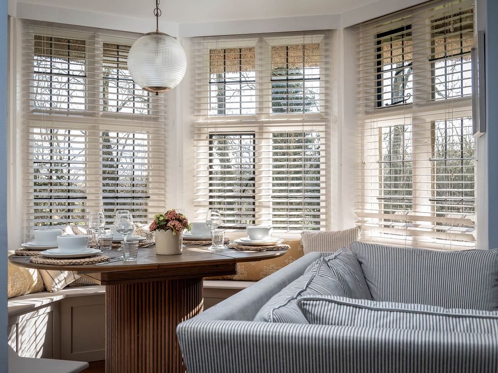 A dining area with a table set for meals at East Lodge in Peterborough