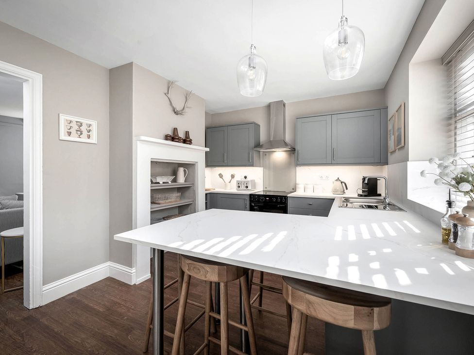 A kitchen with cabinets and a countertop at East Lodge in Peterborough