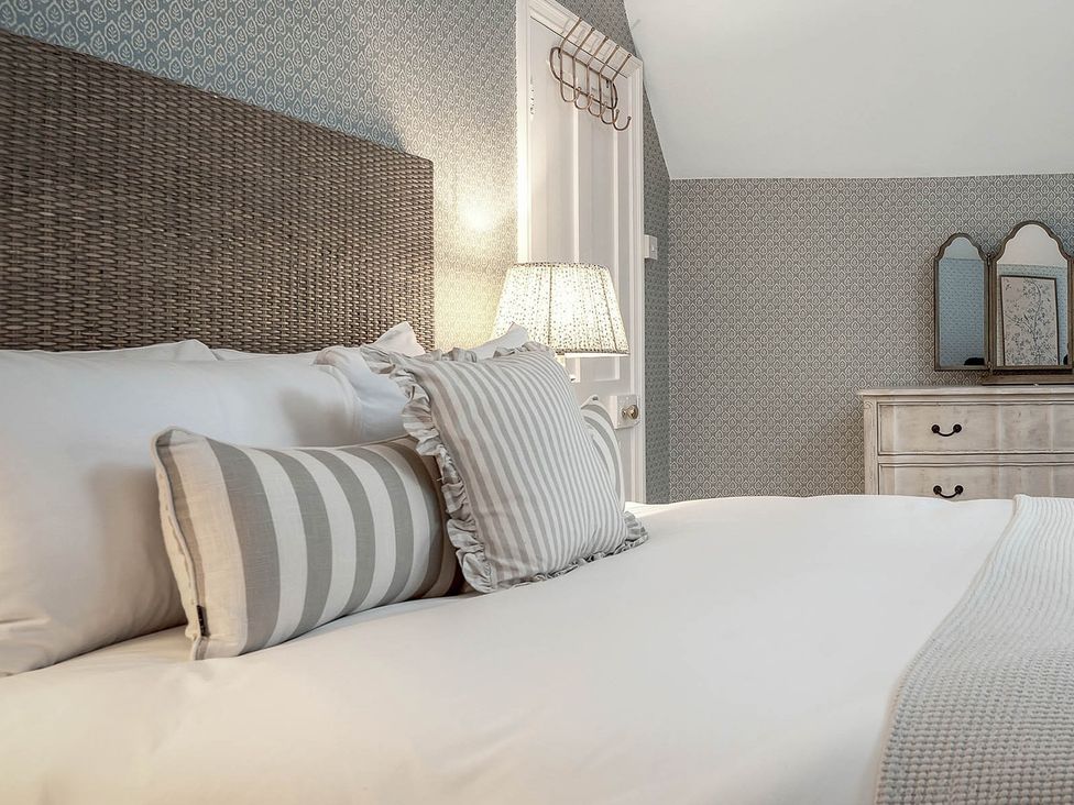 A bedroom with a bed and dresser at East Lodge in Peterborough