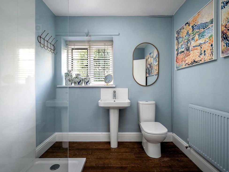 A bathroom with a toilet and sink at East Lodge in Peterborough