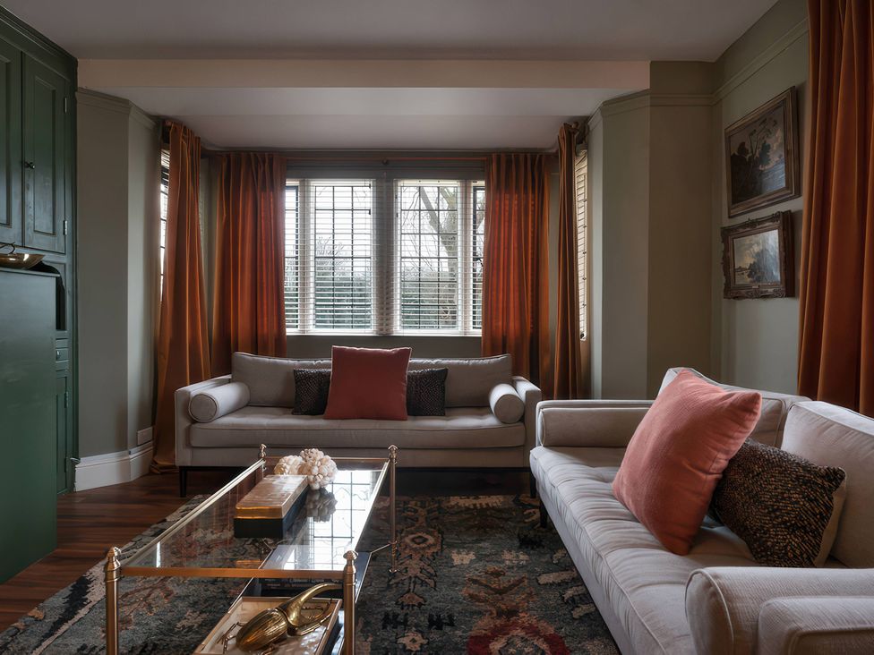 A living room with two sofas and a coffee table at The Gatehouse in Peterborough