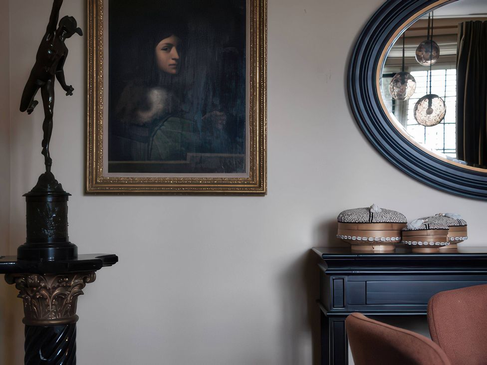 A living room with wall art and decorative items at The Gatehouse in Peterborough